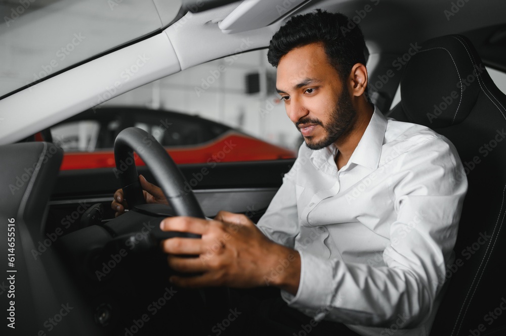 happy indian man buy new biodiesel eco automobile in lux showroom. happy indian man buy new biodiesel eco automobile in lux showroom.