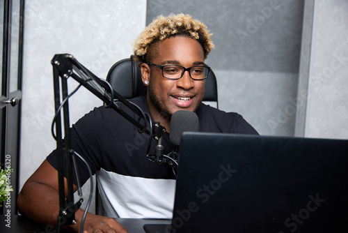 Fotografie Radio DJ with glasses leads a popular program for listeners