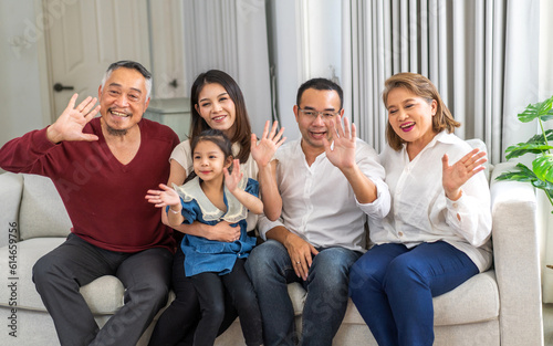 Portrait of happy love asian grandfather with grandmother playing with asian baby and little cute girl say bye, hallo.Big family love with father and mother smiling together.Family and togetherness.