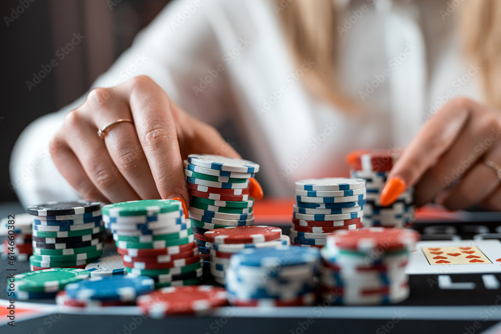 young woman makes a bet with chips in a poker game in a casino young woman makes a bet with chips in a poker game in a casino