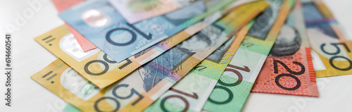 Colorful australian dollars laying on wooden table photo
