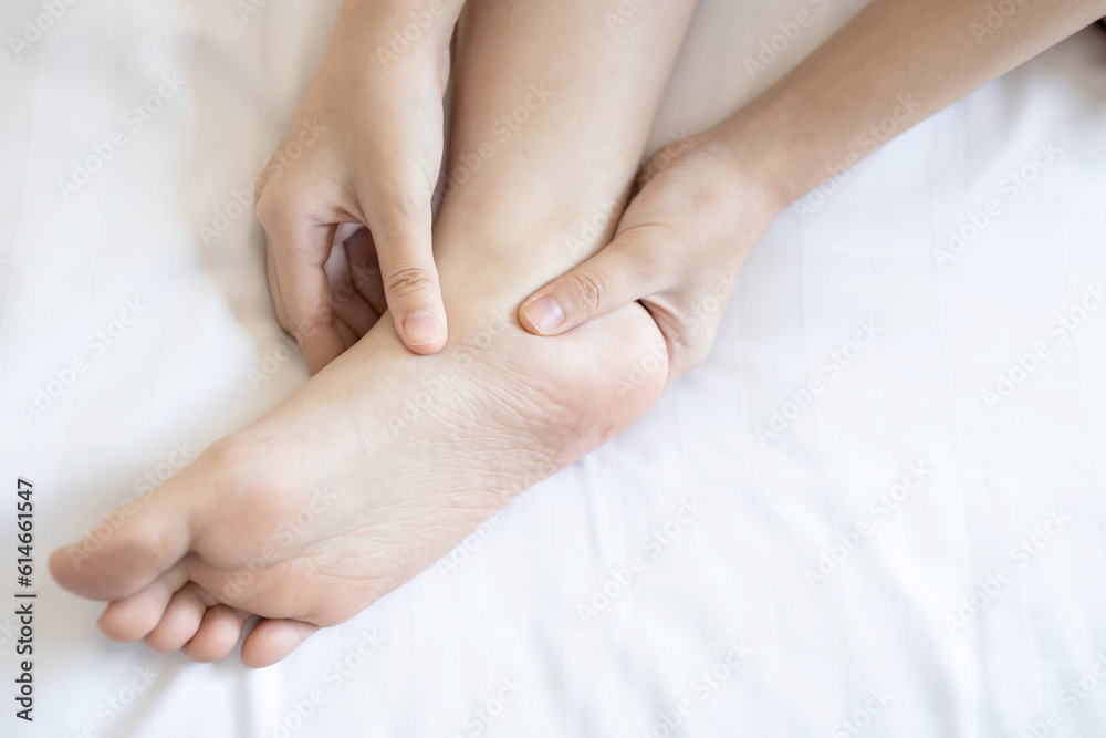 Hands of girl massage her foot,pain under ankle bone, disease of Flat Foot,inflammation of muscle and tendon between foot and ankle from Tibialis Posterior Dysfunction or Problem of Plantar Fasciitis Hands of girl massage her foot,pain under ankle bone, disease of Flat Foot,inflammation of muscle and tendon between foot and ankle from Tibialis Posterior Dysfunction or Problem of Plantar Fasciitis