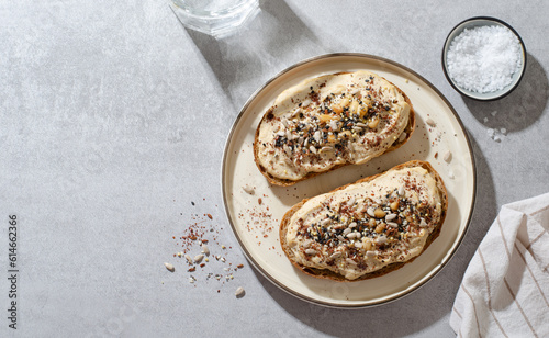 Hummus Toast with Rustic Bread, Vegetarian Snack or Breakfast on Bright Background