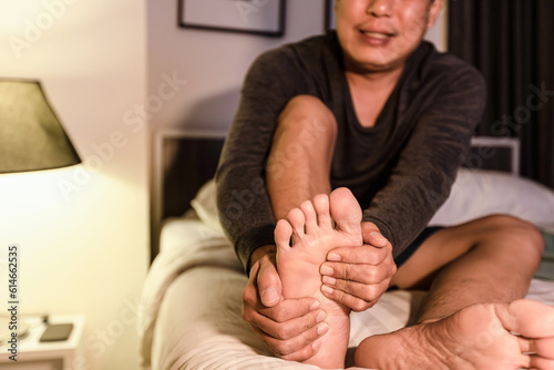 asian middle aged man have severe cramp his calf muscle of leg,adult male people suffering from cramps of foot,problems of peripheral neuropathy,numbness or weakness in leg,beriberi in feet and toes