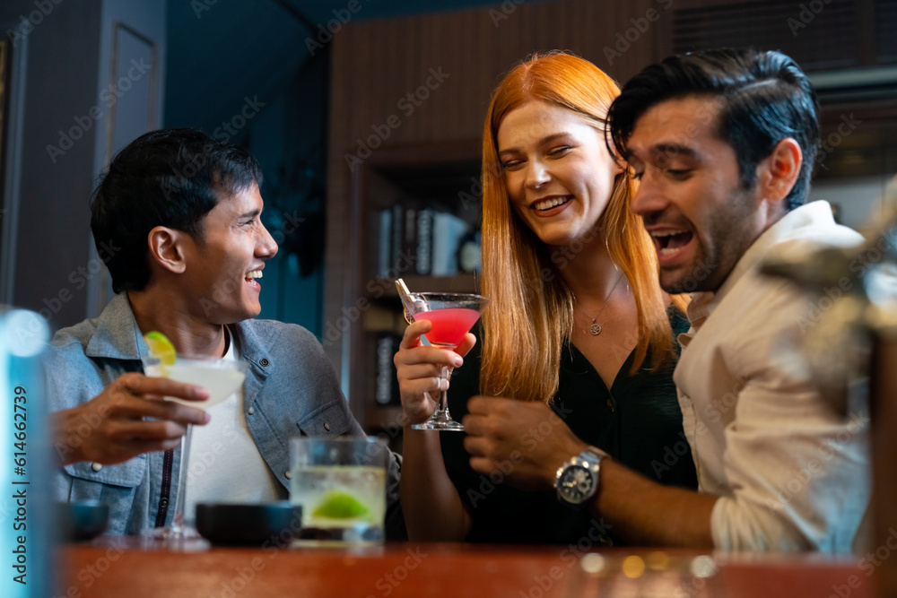 Group of Cheerful people friends celebrating holiday event hanging out party drinking alcoholic cocktail together at restaurant bar. Man and woman enjoy and fun hangout meeting nightlife at nightclub.