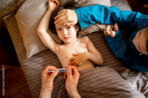 Family taking care of sick child at home