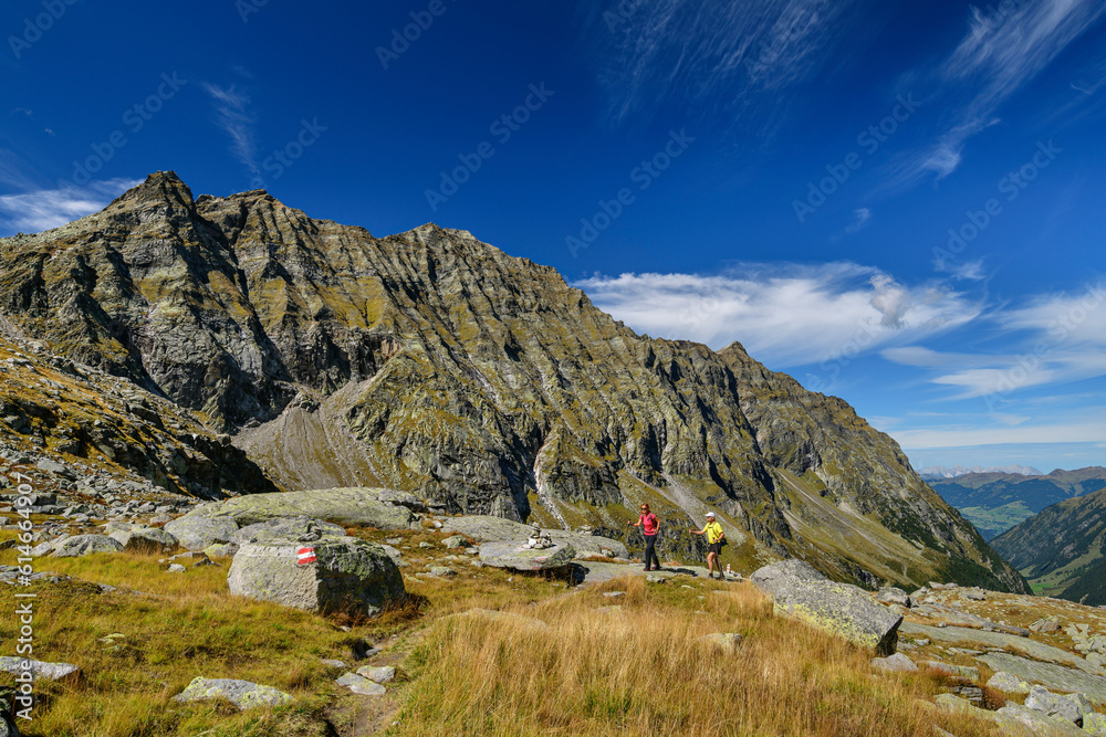 Man and woman hiking on mountain at Hohe Tauern Range in Austria Man and woman hiking on mountain at Hohe Tauern Range in Austria
