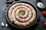 Traditional Raw Spiral Sausages, Meat Round Sausages on Dark Background