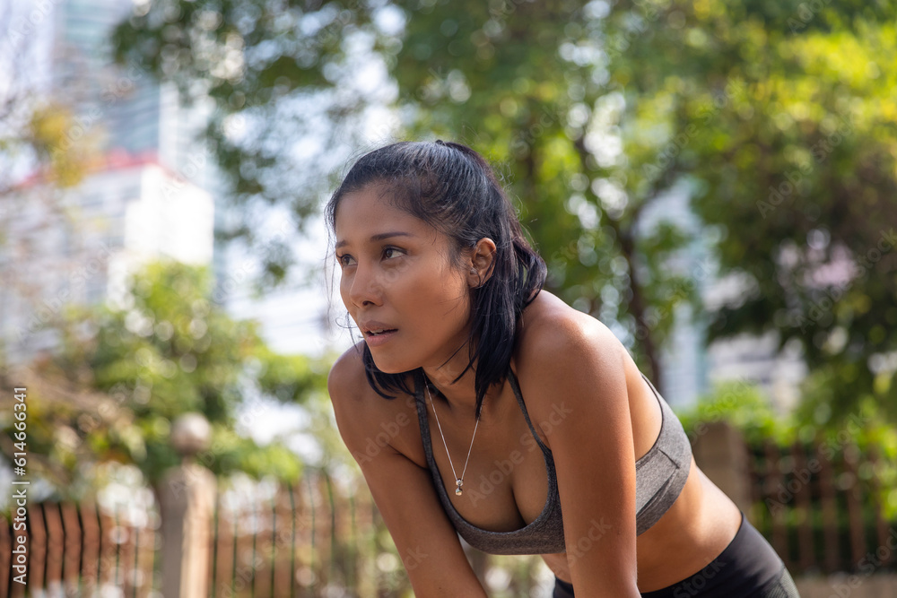 Tired woman taking break after exercise Tired woman taking break after exercise