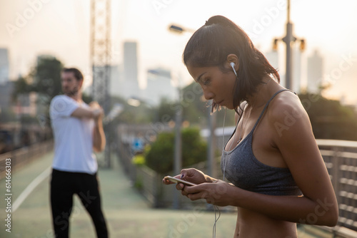 Woman listening to music through smart phone photo