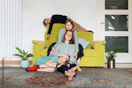 Family relaxing in living room at home photo