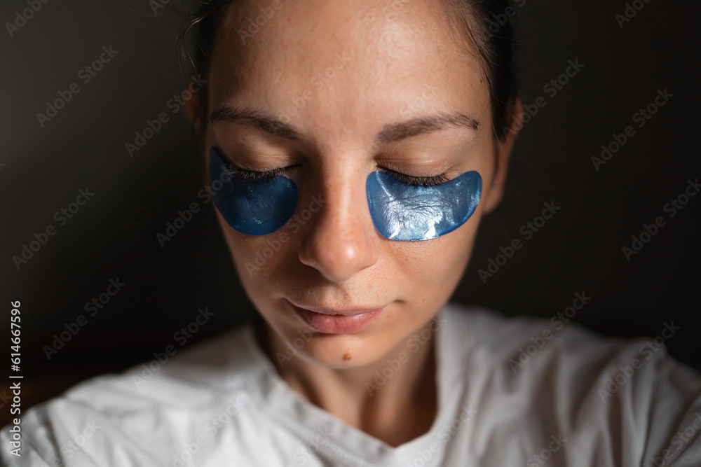 Young adult woman wearing eye patches in sun pocket Young adult woman wearing eye patches in sun pocket