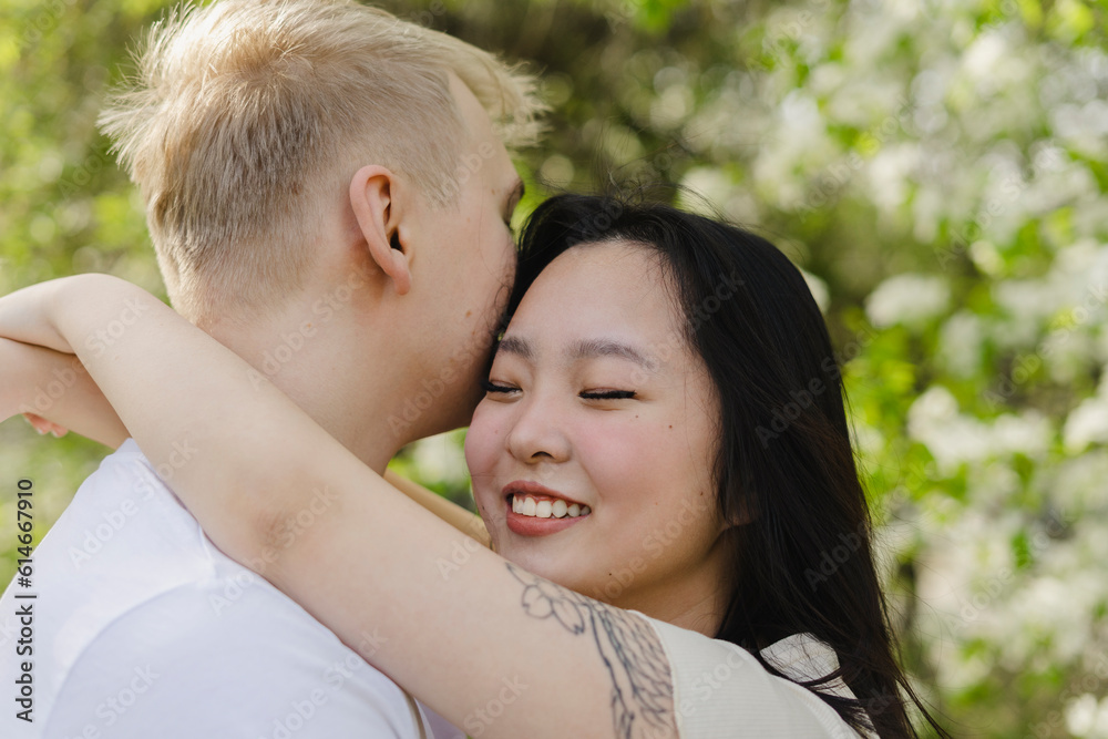 Smiling young woman embracing boyfriend at park Smiling young woman embracing boyfriend at park