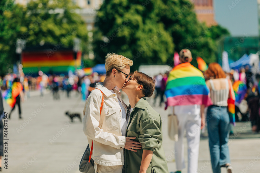 Loving lesbian couple kissing each other at gay pride event Loving lesbian couple kissing each other at gay pride event