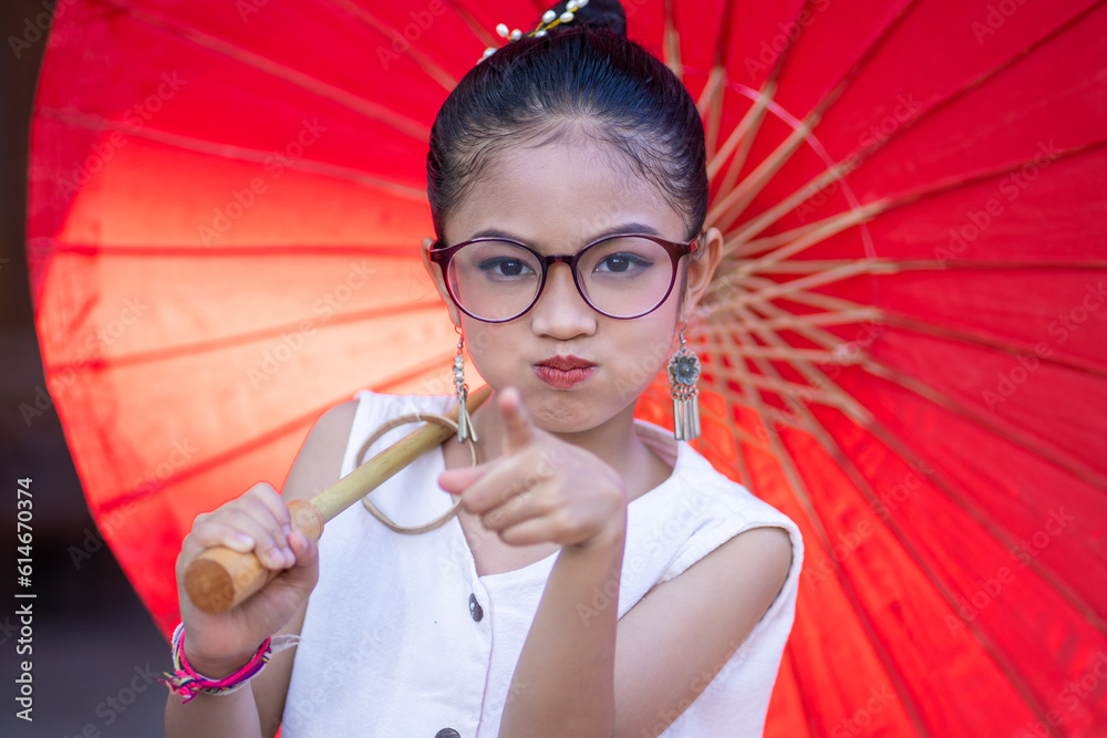 Foto de Portrait of an adorable cute Thai little girl of preschool age wearing Thai dress