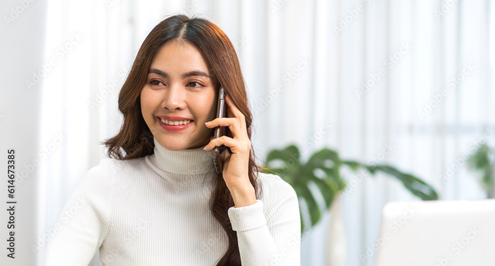 Portrait of smiling happy beauty asian business woman relaxing using digital technology smartphone.Young asian girl work call and talk with friend business team at home Portrait of smiling happy beauty asian business woman relaxing using digital technology smartphone.Young asian girl work call and talk with friend business team at home