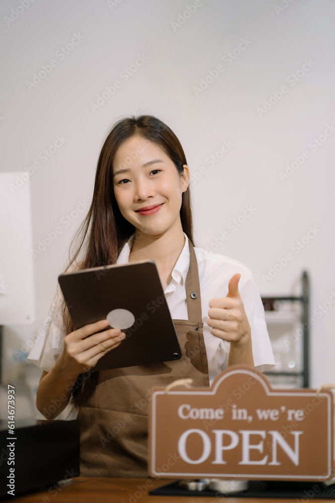 Startup successful small business owner sme beauty girl stand with tablet in her coffee shop. Portrait of asian woman barista cafe owner. SME entrepreneur business concept. Startup successful small business owner sme beauty girl stand with tablet in her coffee shop. Portrait of asian woman barista cafe owner. SME entrepreneur business concept.