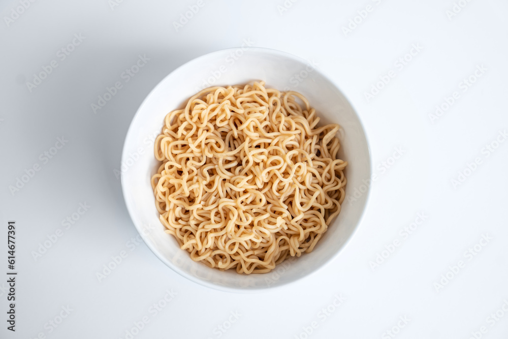 Instant noodles in a white bowl isolated on white background