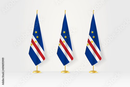Three Cape Verde flags in a row on a golden stand, illustration of press conference and other meetings.
