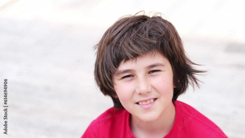 Teen boy with long hair cut looking at camera with interest . High quality 4k footage Teen boy with long hair cut looking at camera with interest . High quality 4k footage