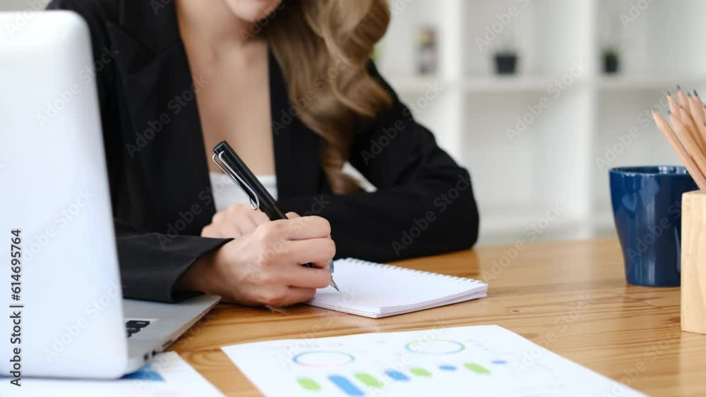 Dolly out of smiling businesswoman making important notes, planning daily appointment in diary Dolly out of smiling businesswoman making important notes, planning daily appointment in diary