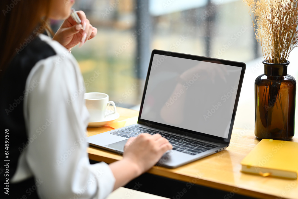 Side view of female employee hand typing on laptop keyboard, checking business email or financial market data before meeting Side view of female employee hand typing on laptop keyboard, checking business email or financial market data before meeting