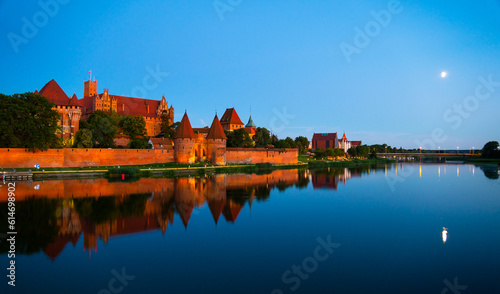 Marienburg castle the largest medieval brick castle in the world in the city of Malbork evening view at night photo