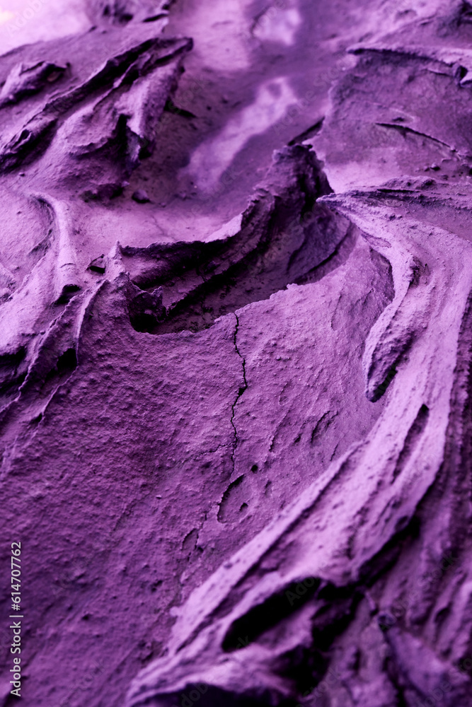 Decorative purple putty background. Wall texture with filler paste applied with spatula, chaotic dashes and strokes over plaster. Creative design, stone pattern, cement.