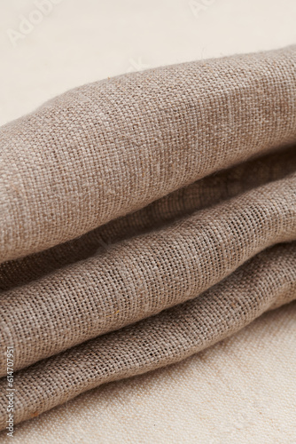 Linen in different textures and colors. Natural fabrics from organic flax and cotton in rolls, homespun textile handmade. Burlap and canvas for eco, rustic, boho, hygge decor .