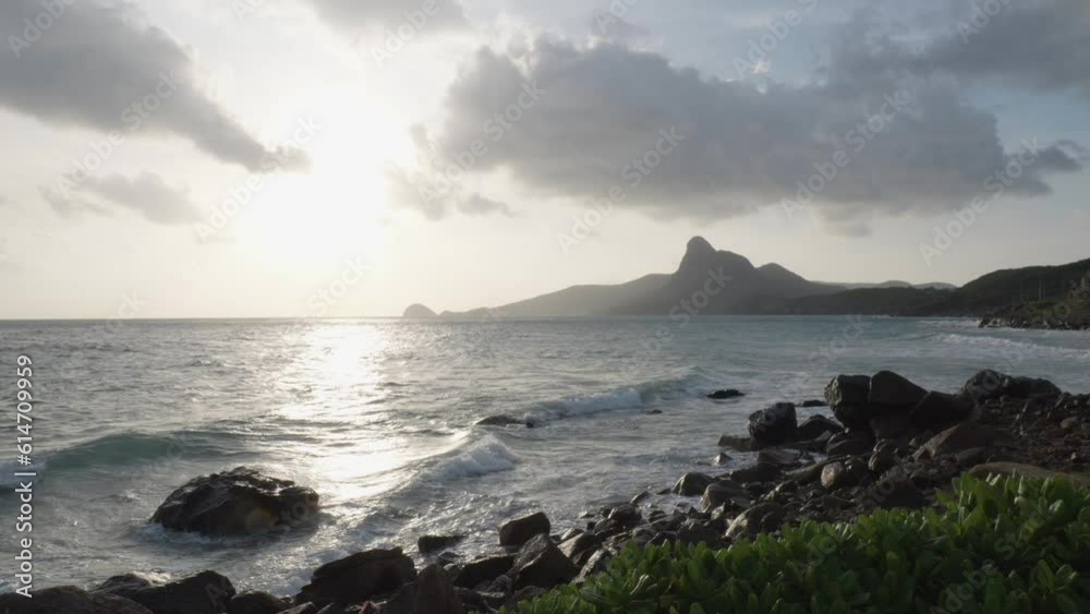 Waves Crashing On The Rocky Seacoast During Daylight In Con Dao Island, Vietnam. Slow Motion Waves Crashing On The Rocky Seacoast During Daylight In Con Dao Island, Vietnam. Slow Motion