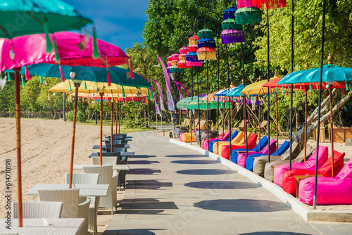 Cafe with colorful umbrellas at beach in Bali, Nusa Dua. Beach club restaurant © artifirsov