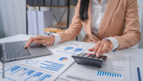 Fototapeta Naklejka Na Ścianę i Meble -  Excited Asian bookkeepers doing bookkeeping, accounts payable, assets, book value, equity, inventory, liabilities, cost of goods sold, depreciation, expenses, Gross profit, diversification, liquidity