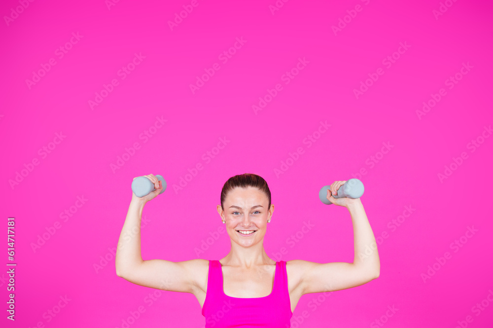 Smiling strong sportswoman lifting weights Smiling strong sportswoman lifting weights
