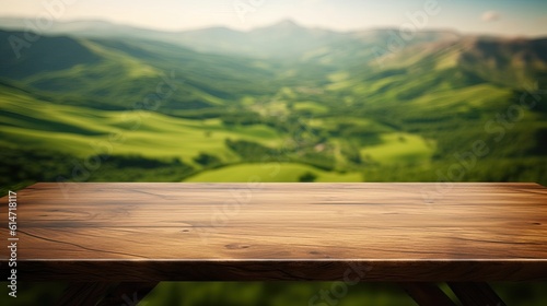Wooden table with landscape of mountains, green hills, meadow and countryside.