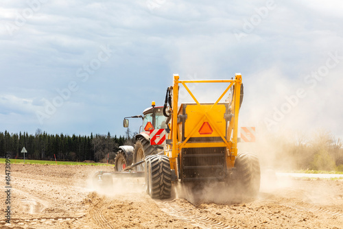 Tractor plowing field in farm