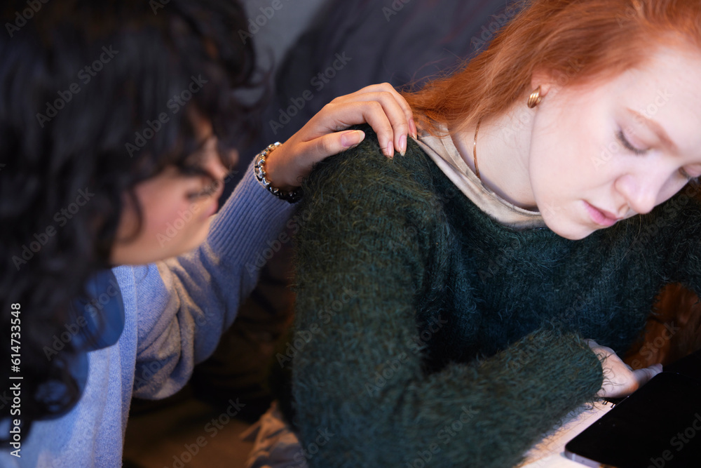 Female friends sitting together where one comforts the other who is depressed Female friends sitting together where one comforts the other who is depressed