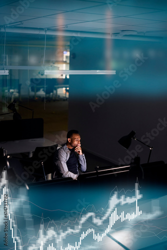 Male finance specialist working in office at night