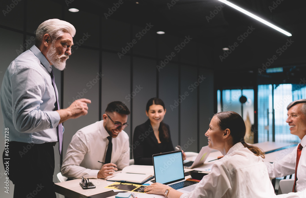 Fototapeta premium Boss speaking to cheerful employees