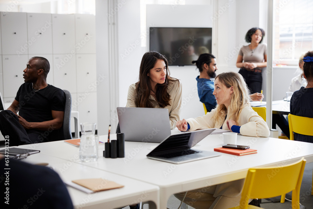 Group of business people discussing project in office Group of business people discussing project in office