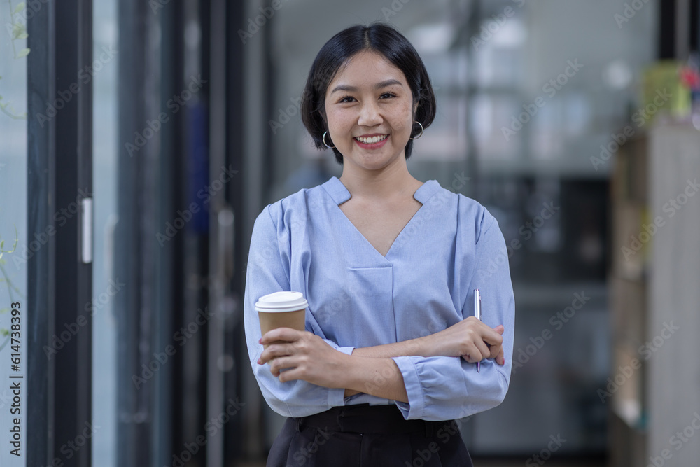 Young asian woman, professional entrepreneur standing in office clothing, smiling and looking confident, workplace office background
