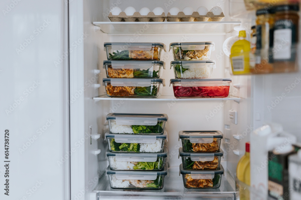 Fridge filled with lunch boxes as part of healthy meal prep Fridge filled with lunch boxes as part of healthy meal prep