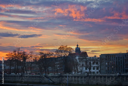 A bright colourful sunset in Krakow, Poland. City evening scenery on the Vistula promenade