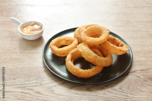 fried onion ring with flour dipping cheese and mayonnaise sauce on plate
