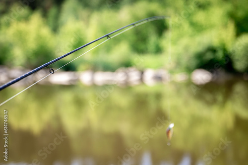 Fishing rod on a blurred background of the lake.