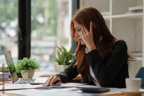 Deadline with young business woman feeling stressed concept. Business woman working at office, business finance concept © itchaznong