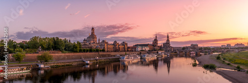 Colorful sunset above the buildings of Dresden city center, royal palace with reflection on the Elbe river