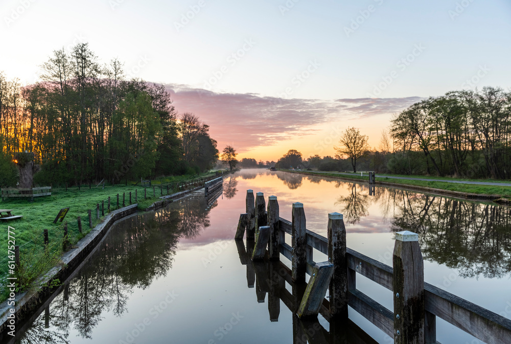 Sunrise over the water channel in the Flevoland