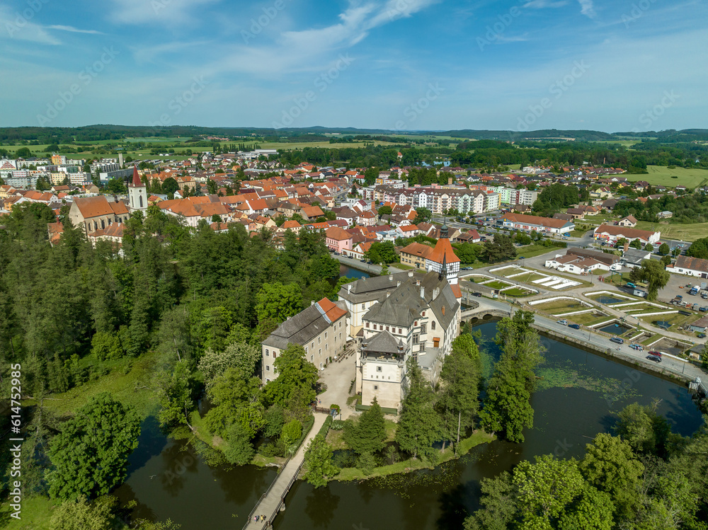 Aerial view of Blatna medieval water castle with towers,  turrets, plus extensive grounds in Bohemia