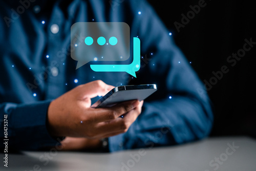 Technology, communication, Social media text messaging concepts, Businessman using smartphone texting message while sitting on table with in work office.