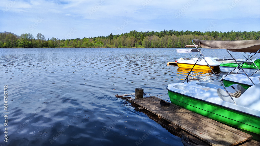 Plastic catamarans are in a row on the water surface of pond. Summer vacation on the water. summer Entertainment